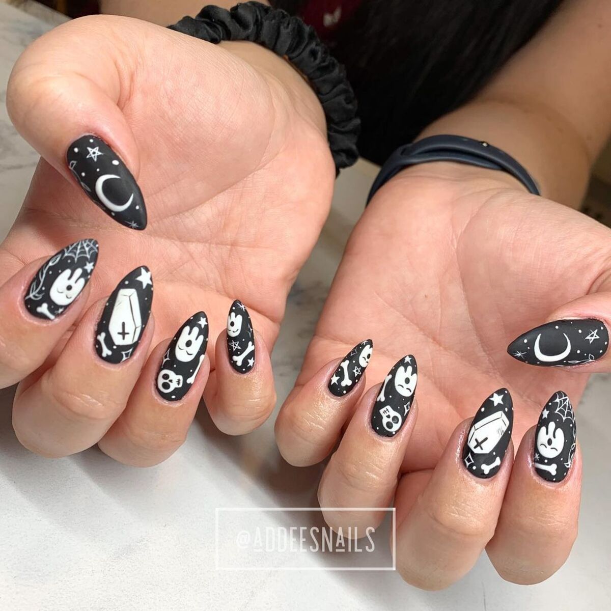 11. Playful Gothic Icons on Almond Nails