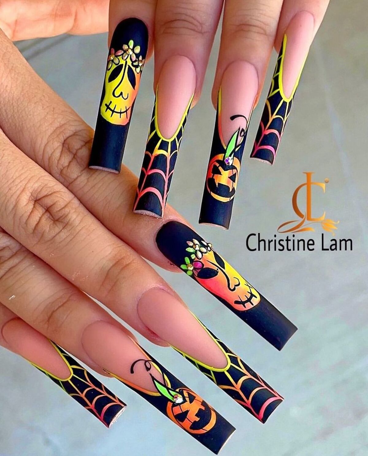 13. Neon Skeletons and Pumpkins on Extra Long Nails