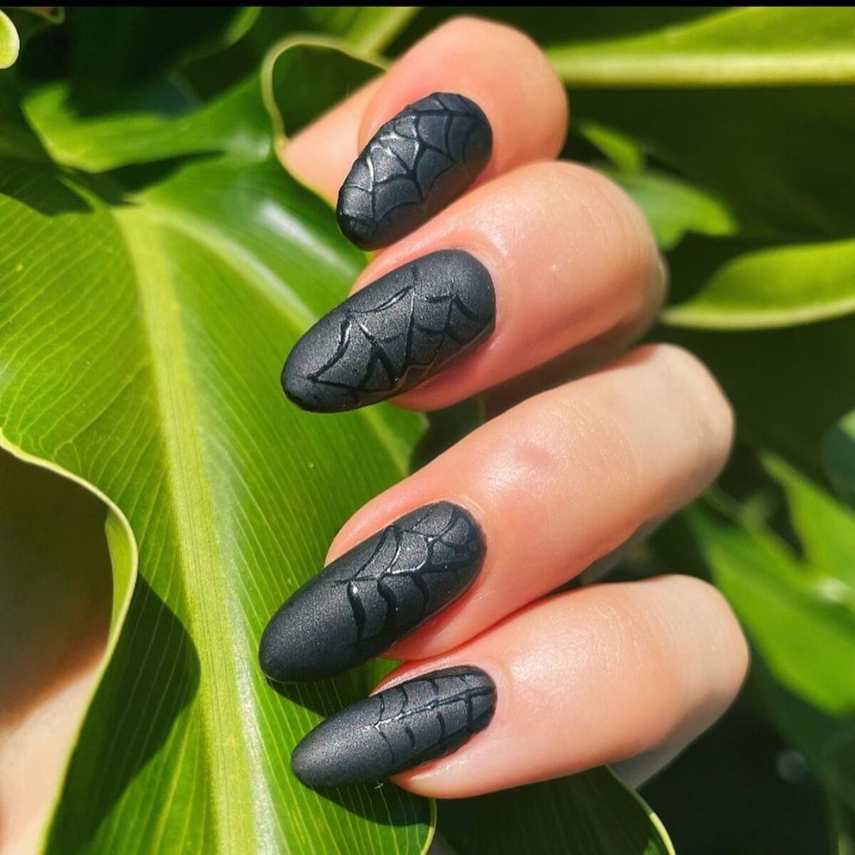 16. Glossy Black Nails with 3D Spiderwebs