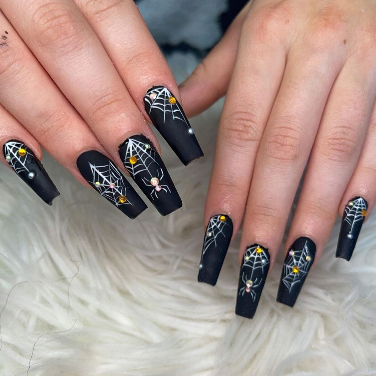 24. Rhinestone-Studded Spiderwebs on Matte Black