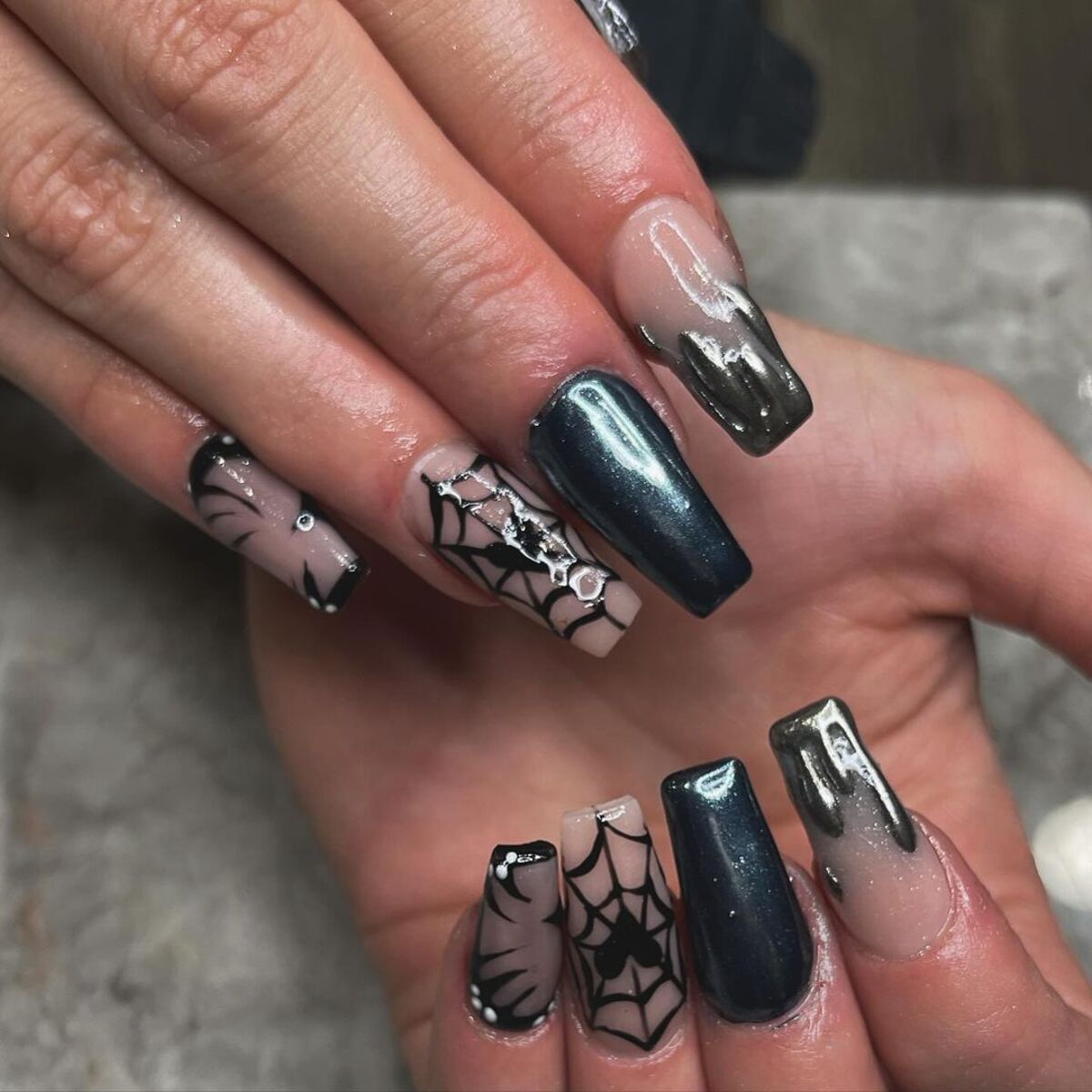 26. Metallic Spiders on Nude and Black Nails