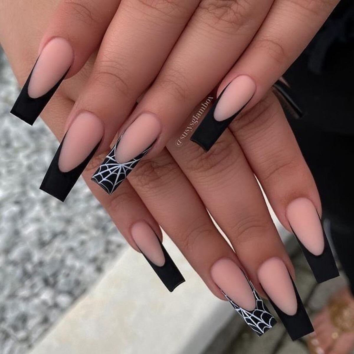 2. Elegant Black French Tips with Spiderweb Accents