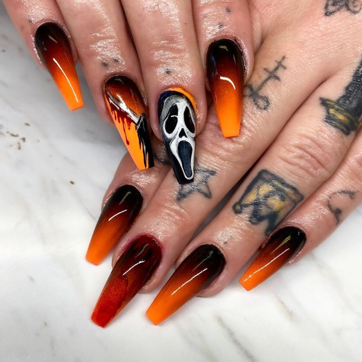 6. Fiery Ombre Nails with Screaming Skull Accent