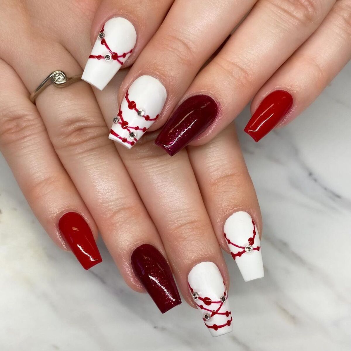 15. Festive Red and White Nail Art with Rhinestones