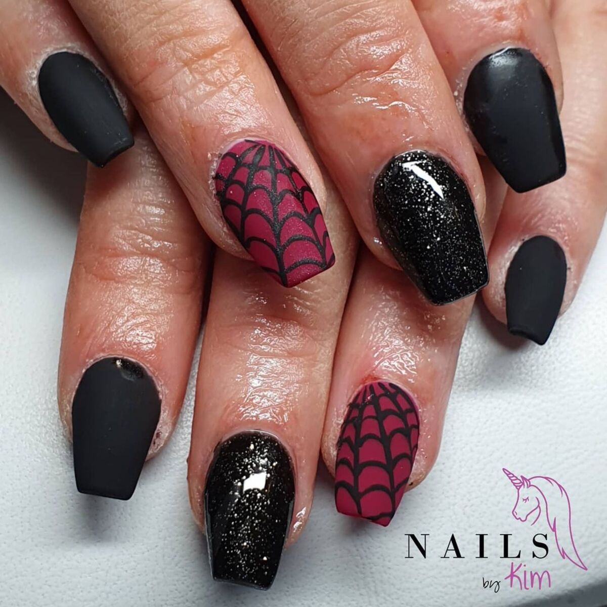 8. Glittery Spider Webs and Matte Black Elegance