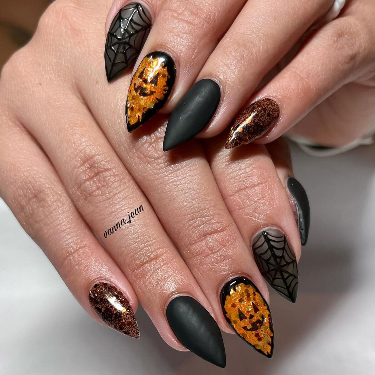 1. Bewitching Pumpkin and Spider Web Nails