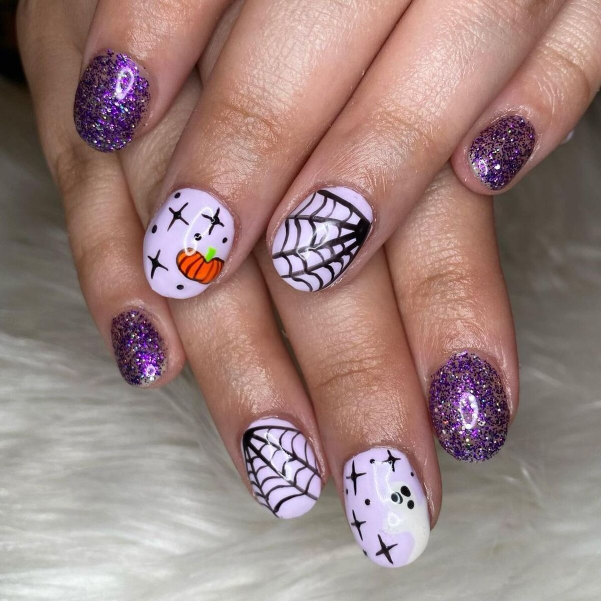 22. Glittering Pumpkin and Web Nail Art