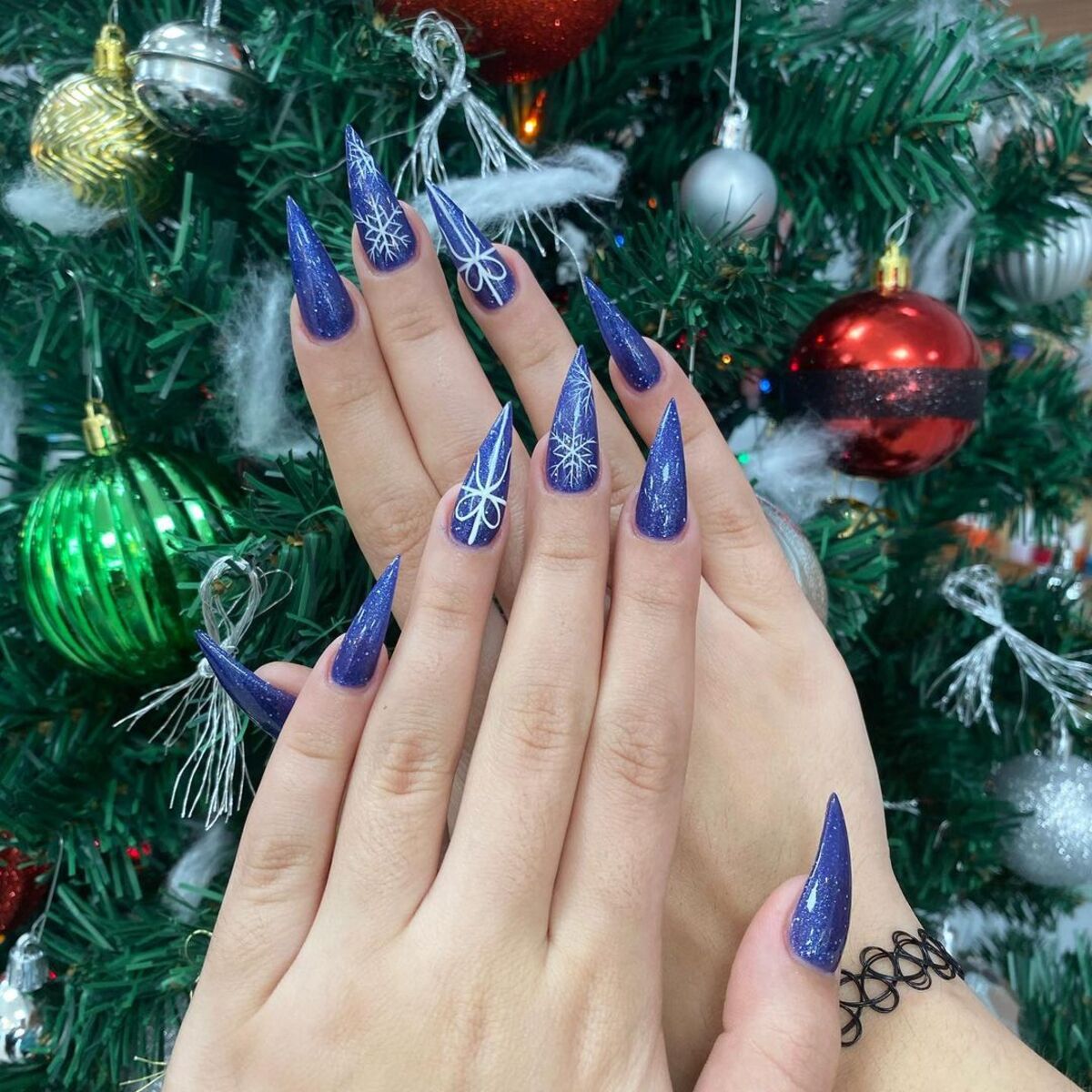 22. Deep Blue Snowflake Stiletto Nails