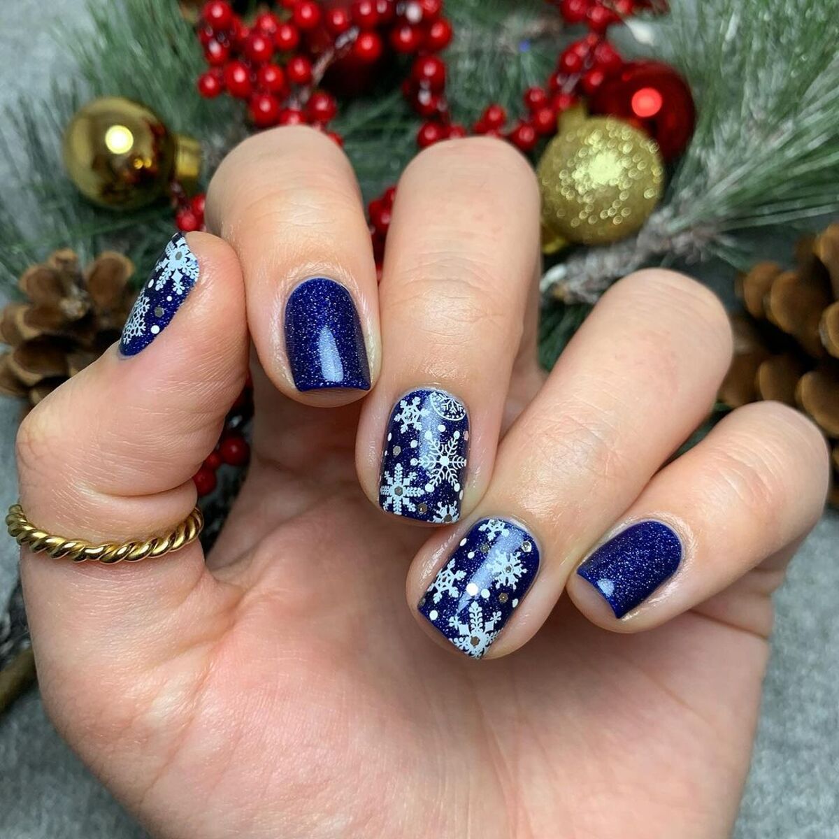 23. Short Navy Nails with Snowflake Patterns