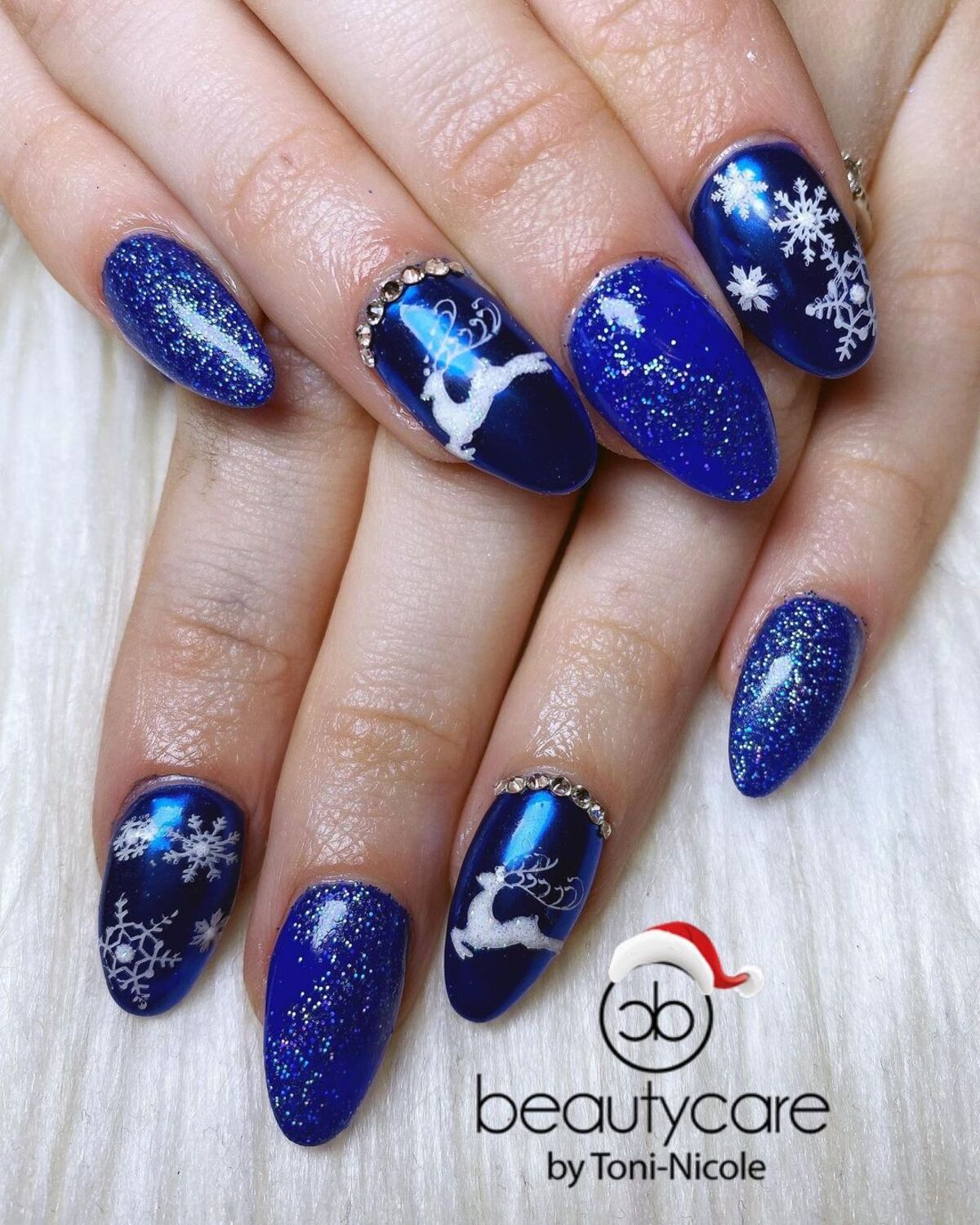 27. Reindeer and Snowflakes on Blue Glitter Nails