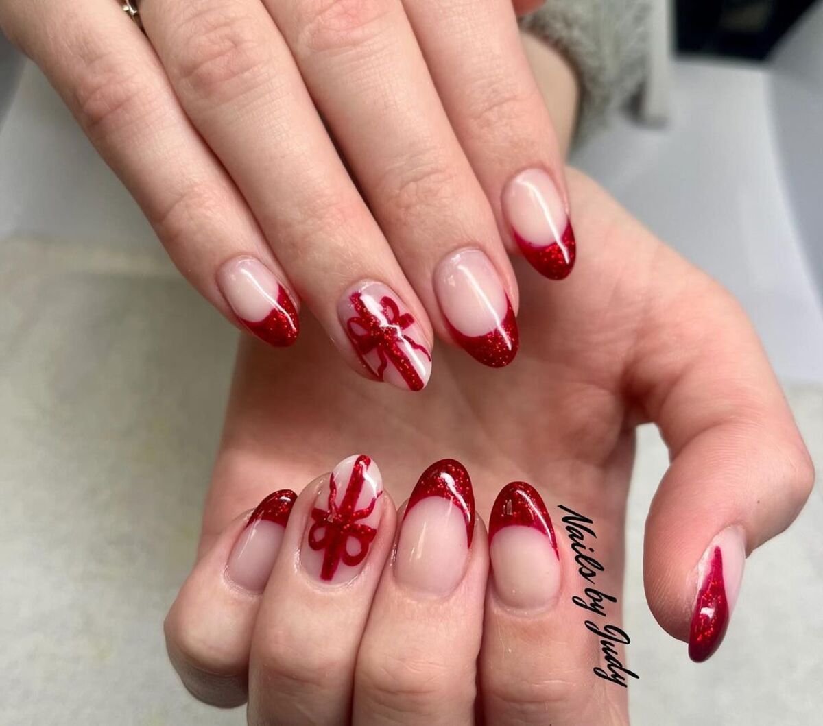 13. Red Glitter French Tips with Gift Bow Accents