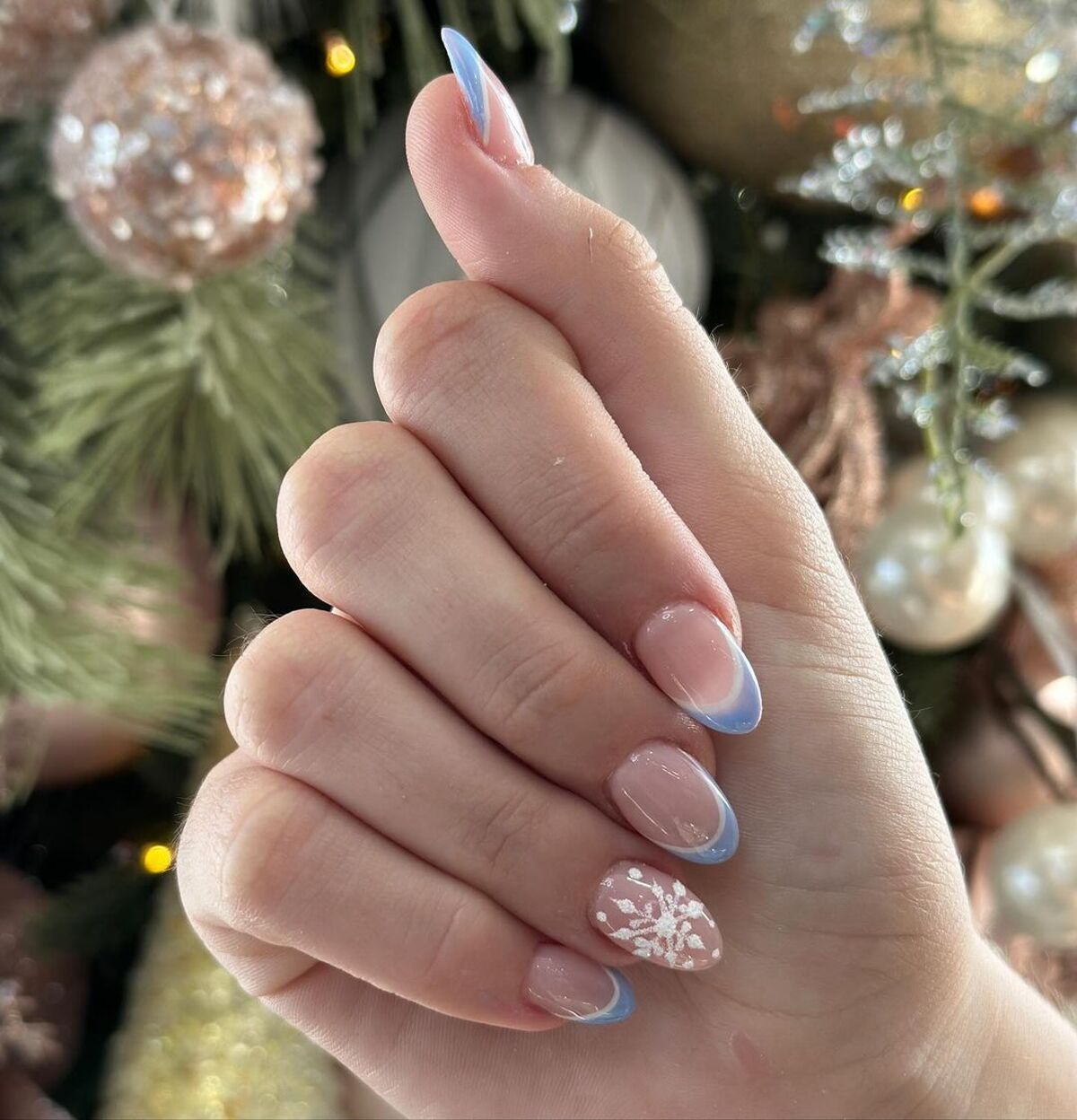 22. Delicate Blue French Tips with Snowflake Art