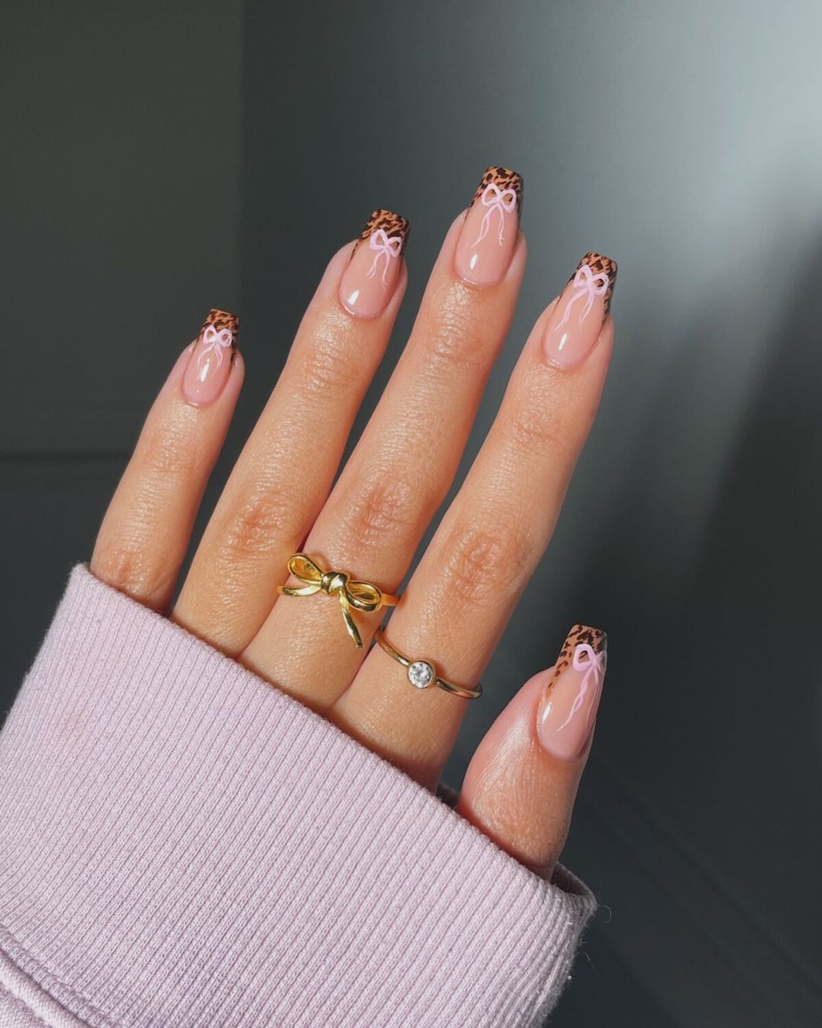 25. Leopard French Tips with Pink Bow Accents