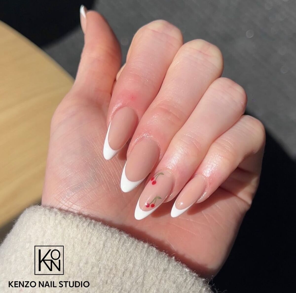 26. Classic White French Tips with Festive Cherry Detail