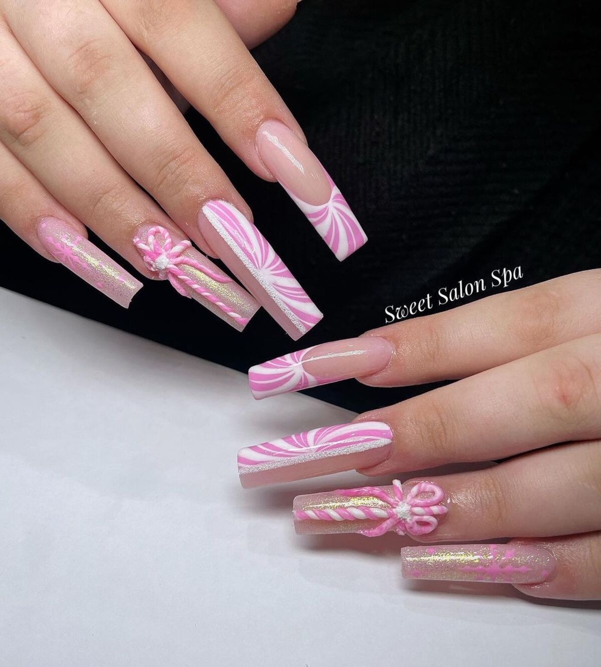 18. Pink and White Peppermint Swirl Nails