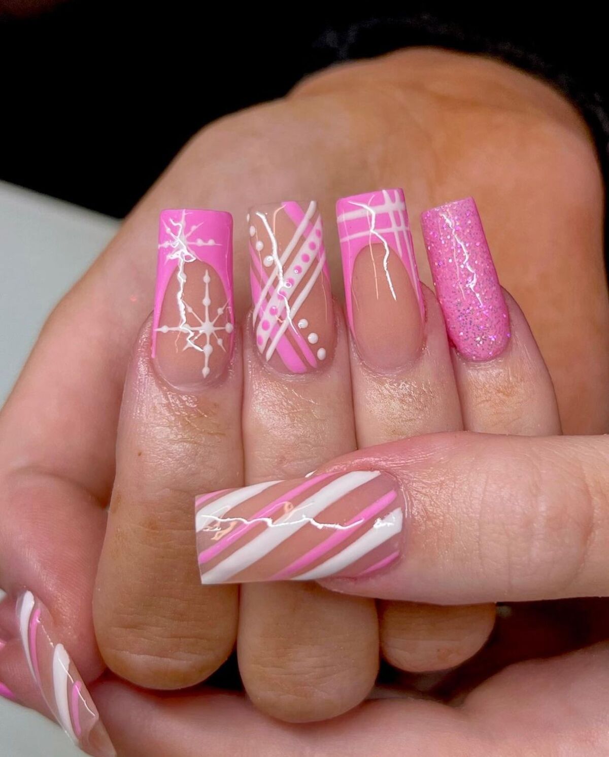 20. Festive Pink and White Holiday Plaid Nails