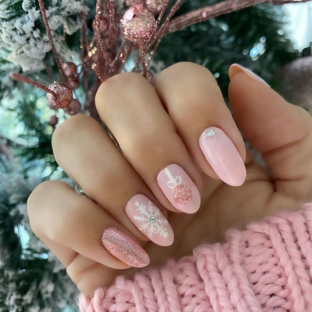 27. Subtle Pink and Glittery Christmas Nails