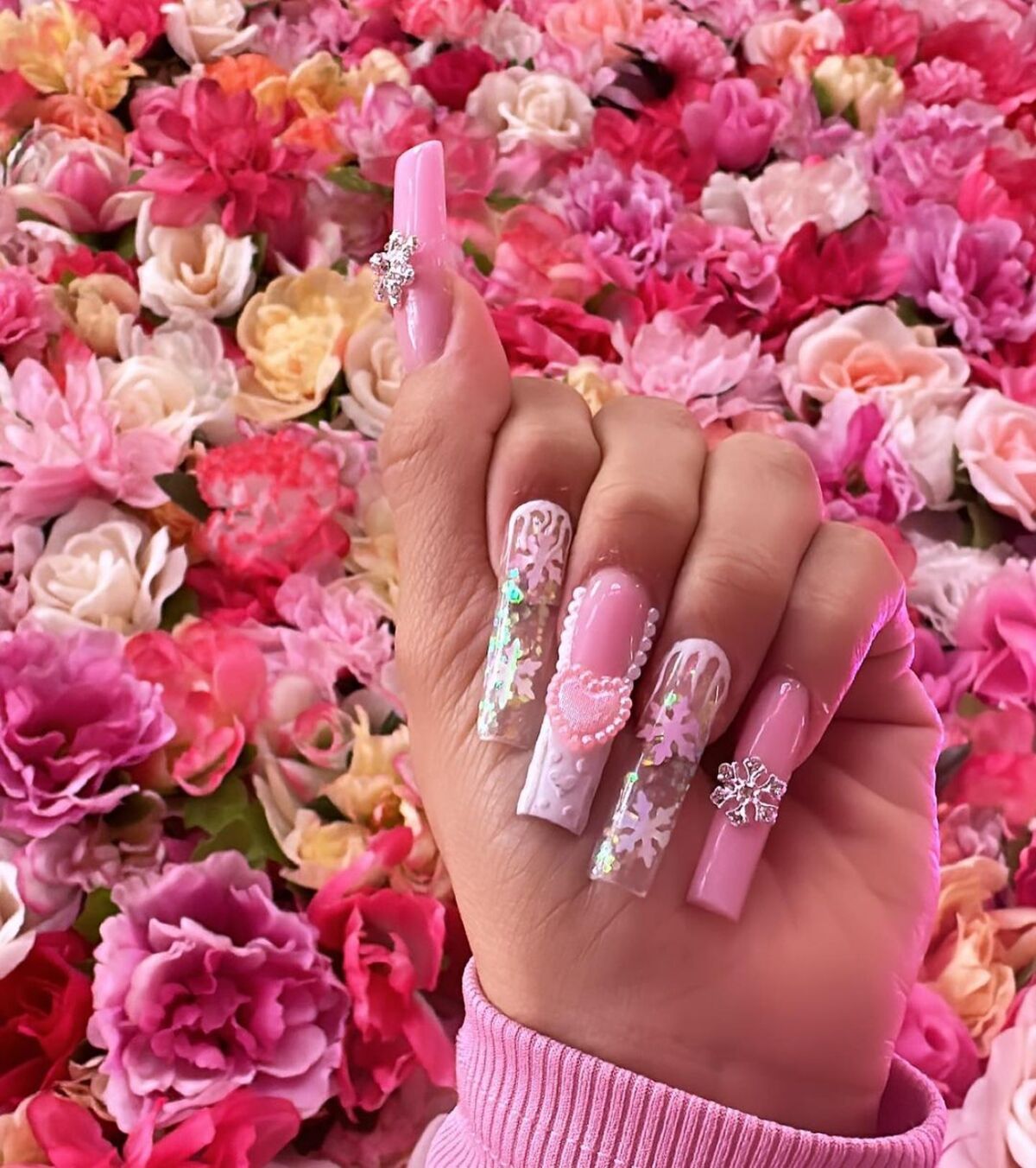 31. Glamorous Pink Snowflake and Heart Accent Nails