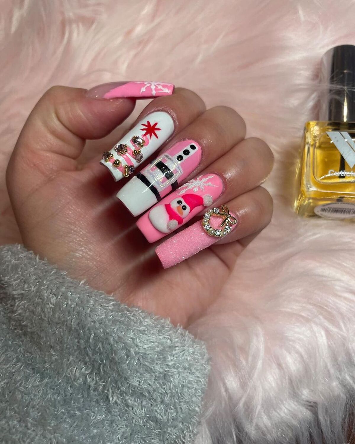 5. Playful Santa and Snowman Pink Christmas Nails