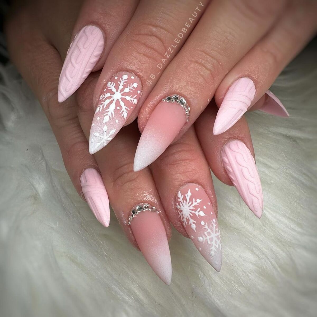 8. Frosted Pink Stiletto Nails with Snowflakes