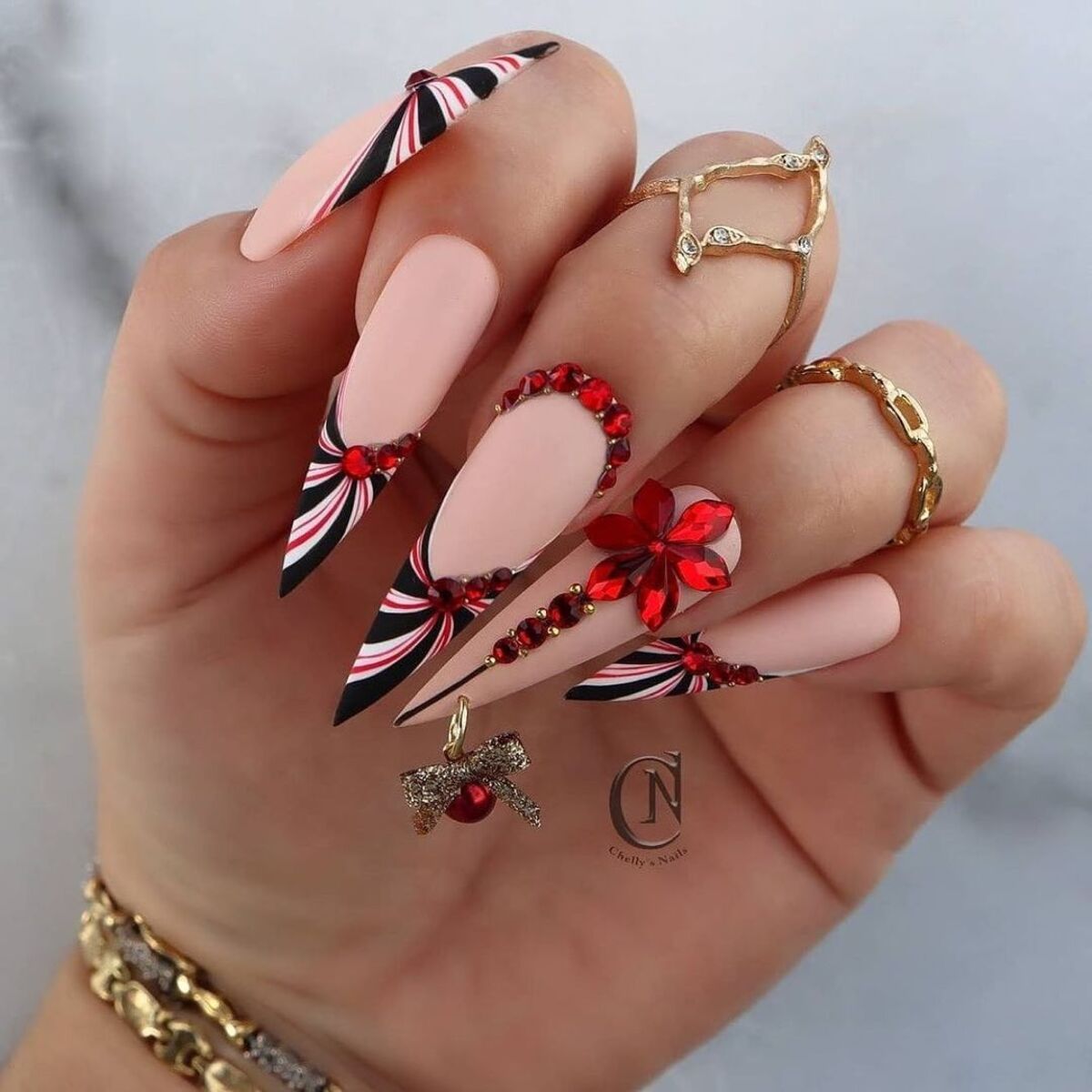 16. Bold Stiletto Nails with Red Poinsettia Rhinestones