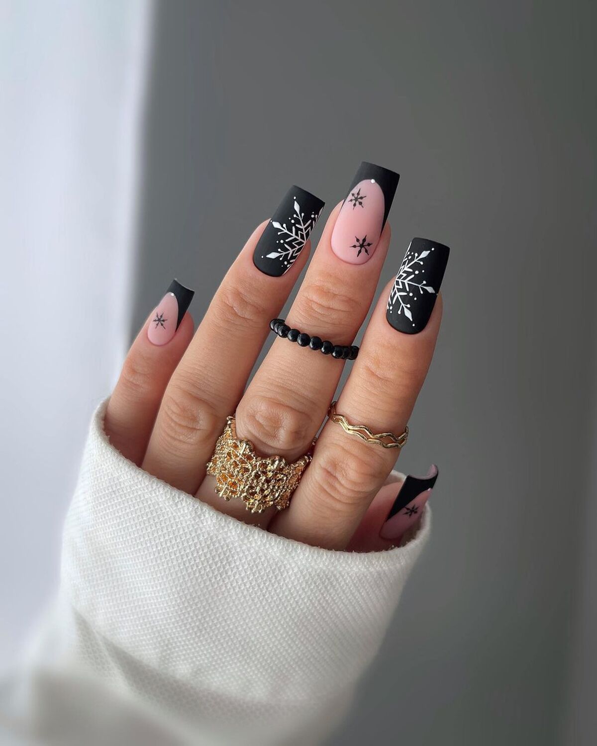 1. Matte Black and Nude Snowflake Elegance