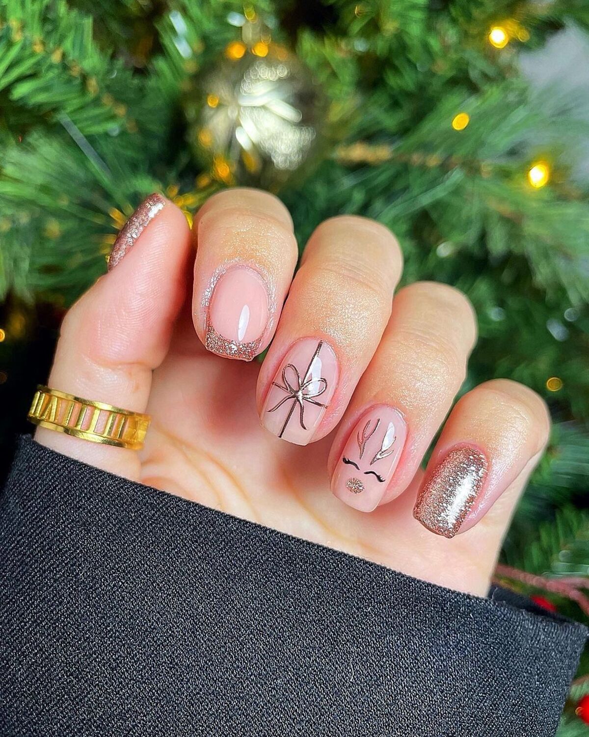 25. Minimalistic Reindeer and Glitter French Tips