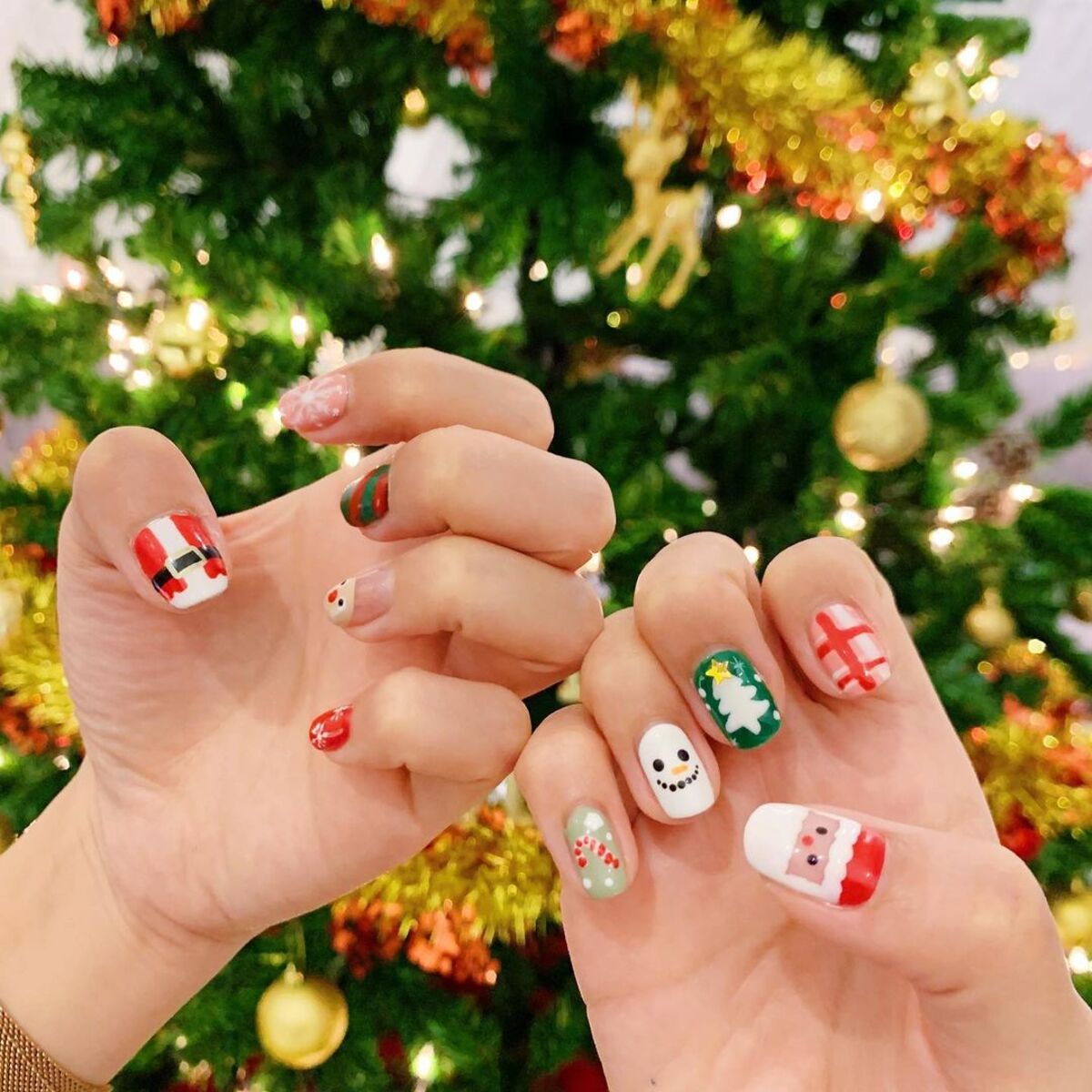 11. Christmas Tree and Snowman Nail Art with Santa Accents