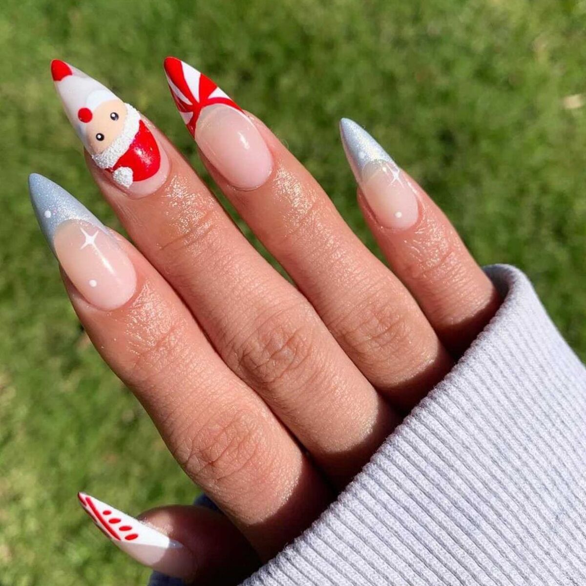 22. Sleek Stiletto Nails with Santa and Candy Cane Design