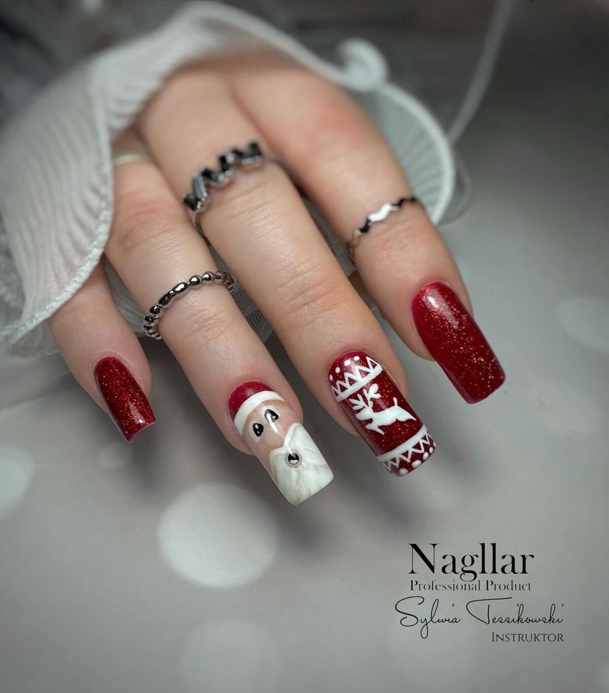 8. Elegant Red and White Nordic Santa Nail Art