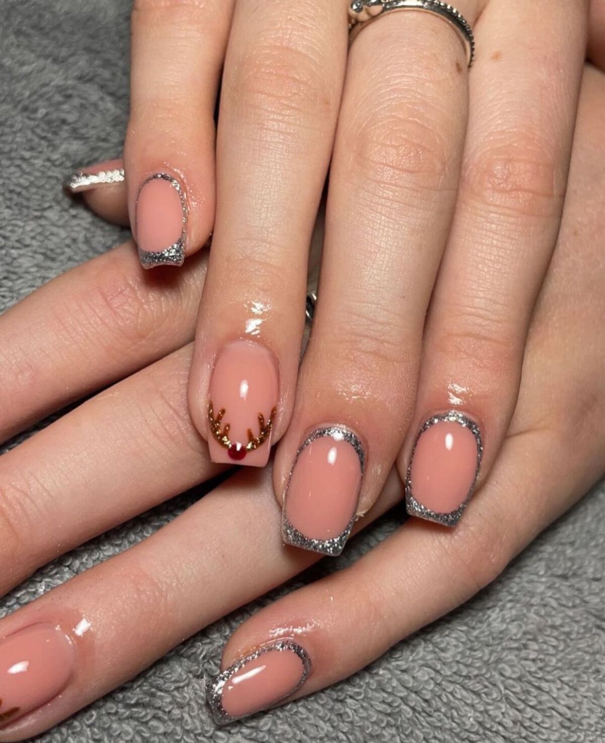 10. Silver Glitter Outlined French Tips with Reindeer Accent