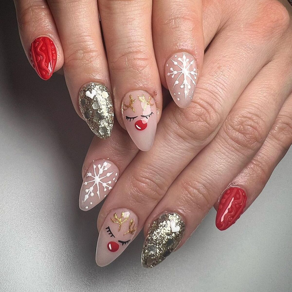 18. Shimmering Red and Gold Reindeer Nails