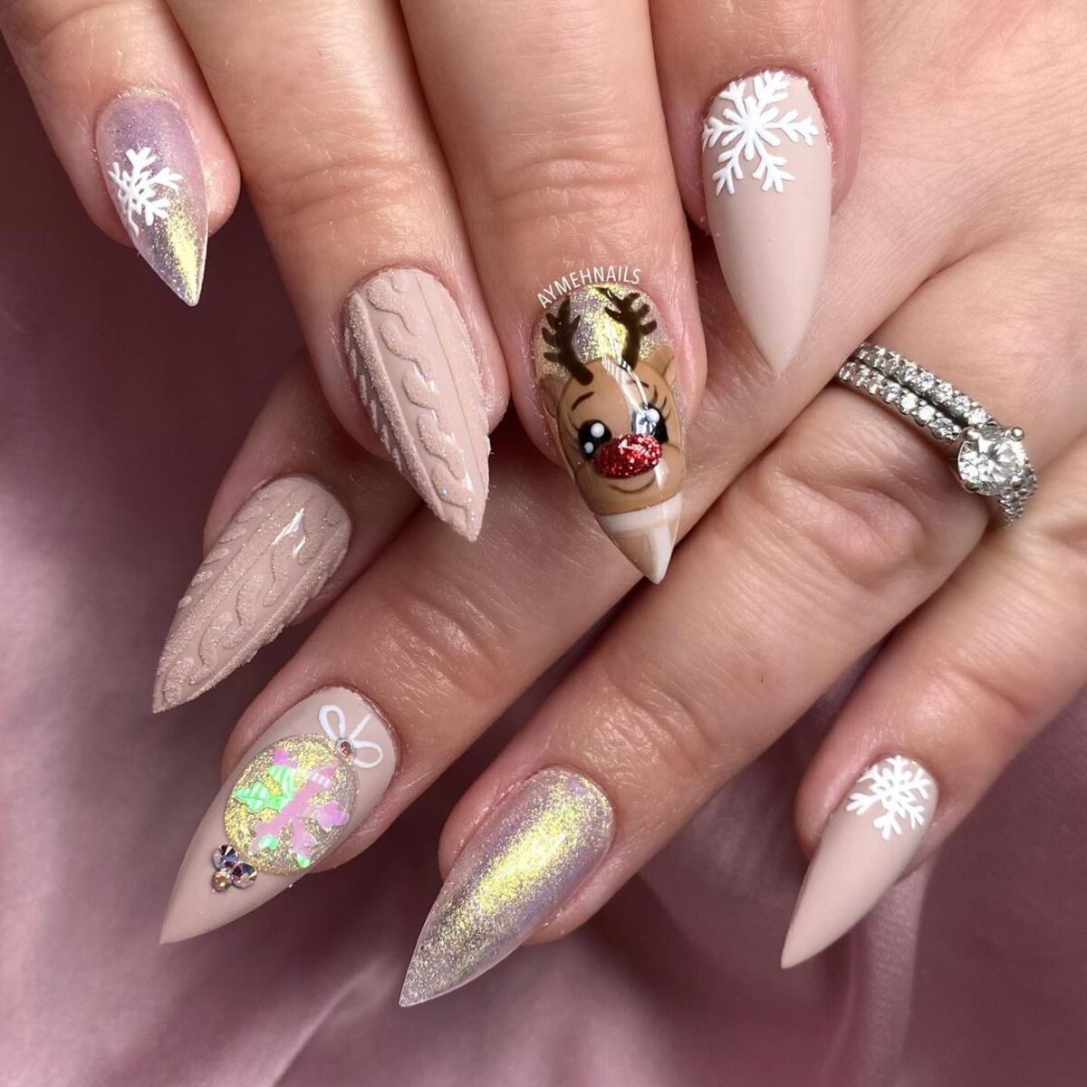 24. Pastel Nude Reindeer and Snowflake Nails