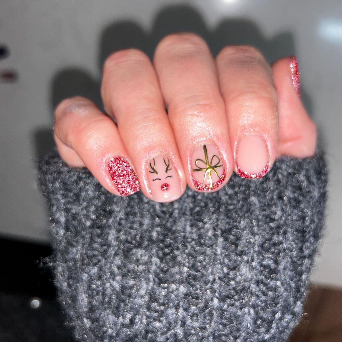 26. Red Glitter Tips and Holiday Reindeer