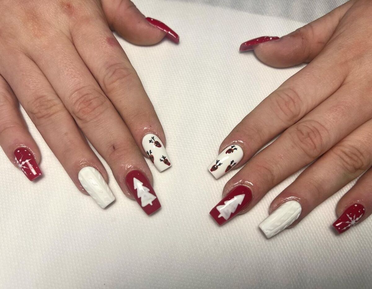 6. Classic Red and White Reindeer Nail Design