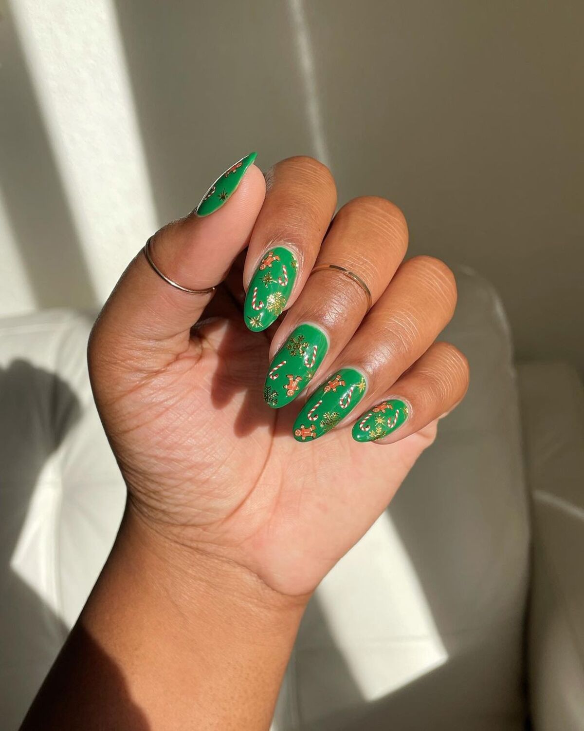 19. Matte Green Nails with Golden Christmas Motifs