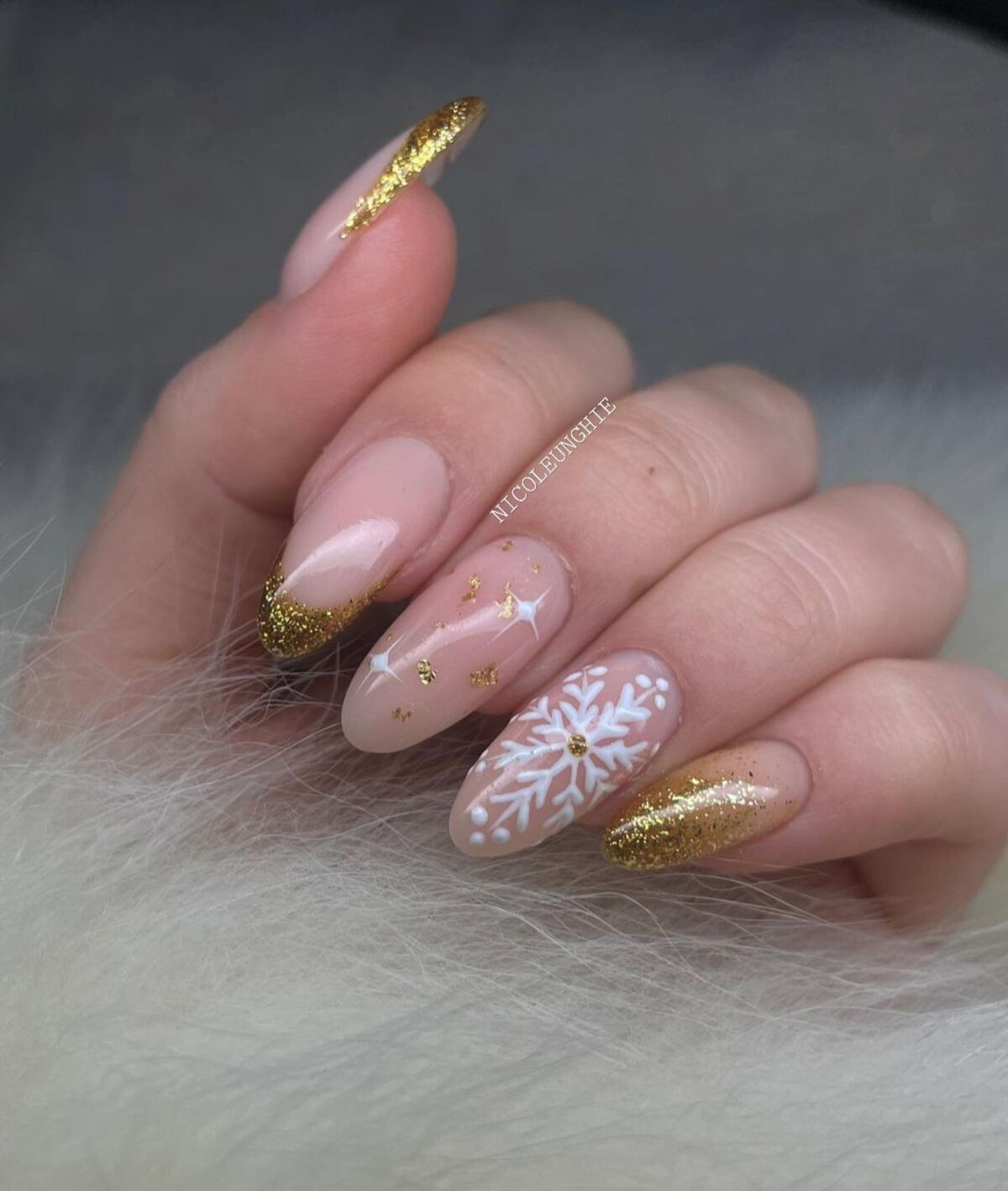 19. Sparkling Gold French Tips with Snowflake Detail