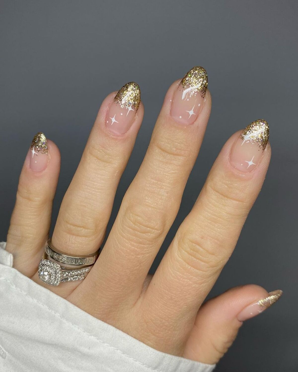 22. Golden French Tips with Starry Shine