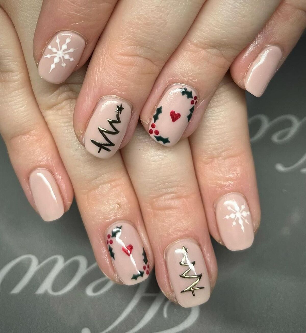 11. Festive Accent Nails with Holly