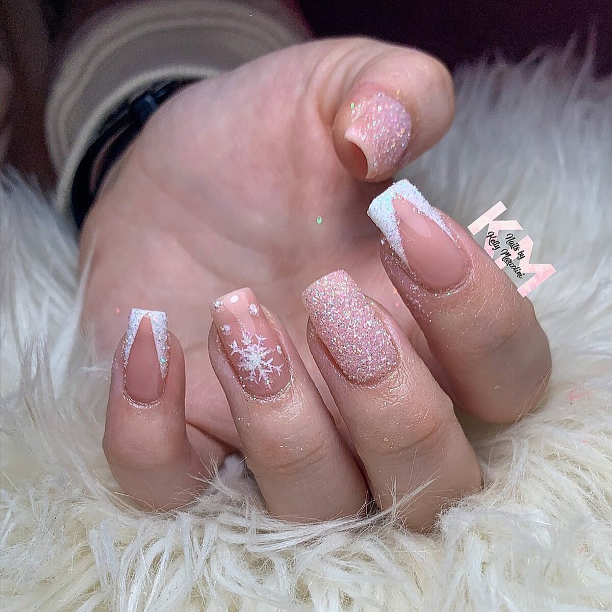 19. Sparkling Glitter French Tips with Snowflake Detail