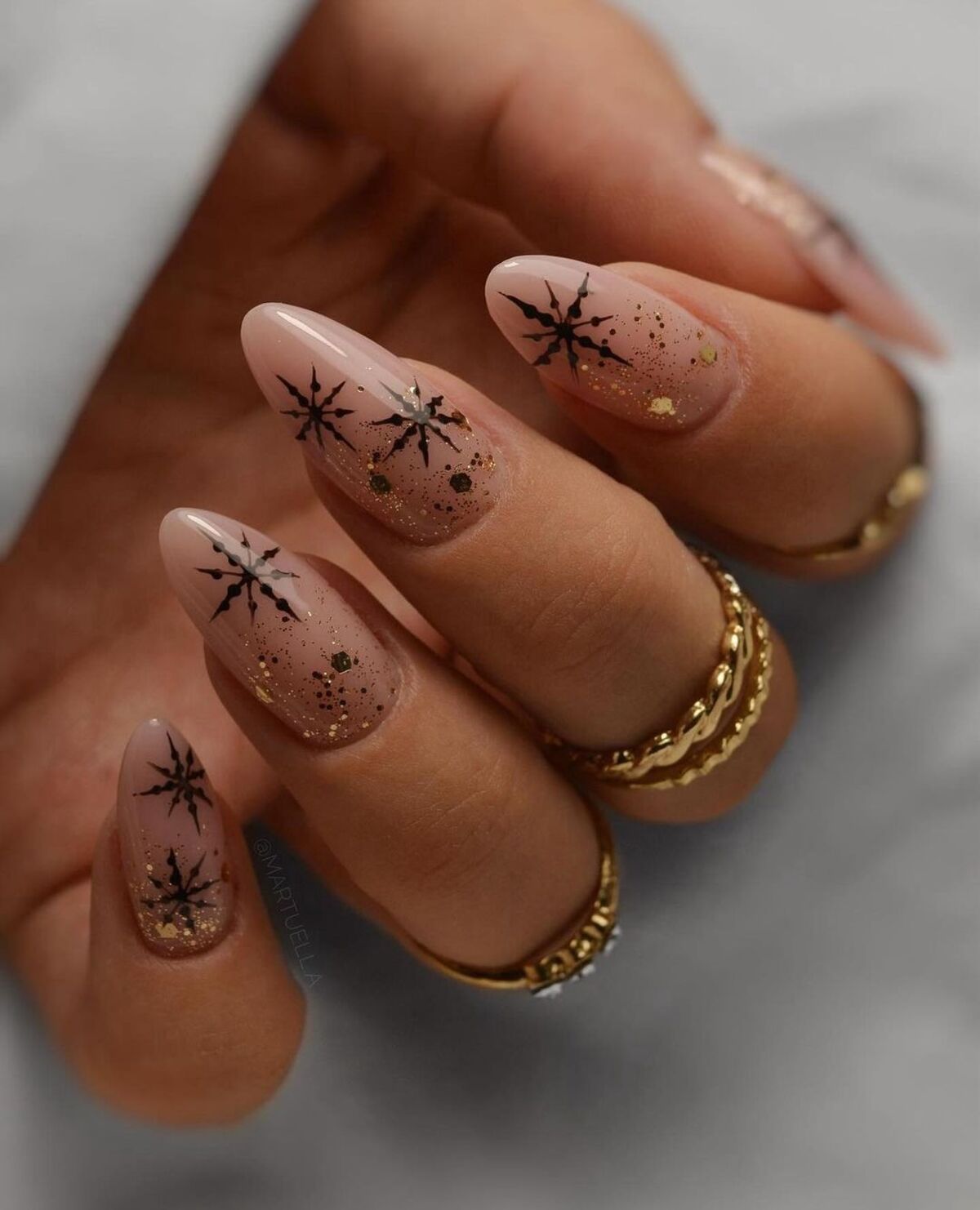 20. Black Snowflakes on Glittered Nude Nails