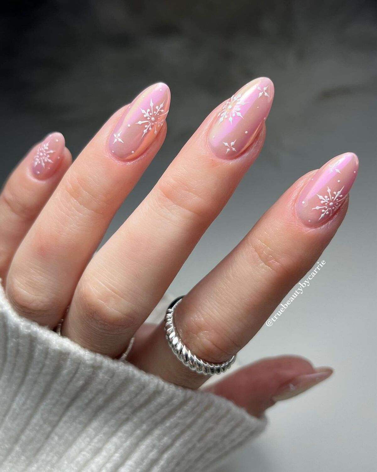 24. Soft Snowflakes on Nude Almond Nails