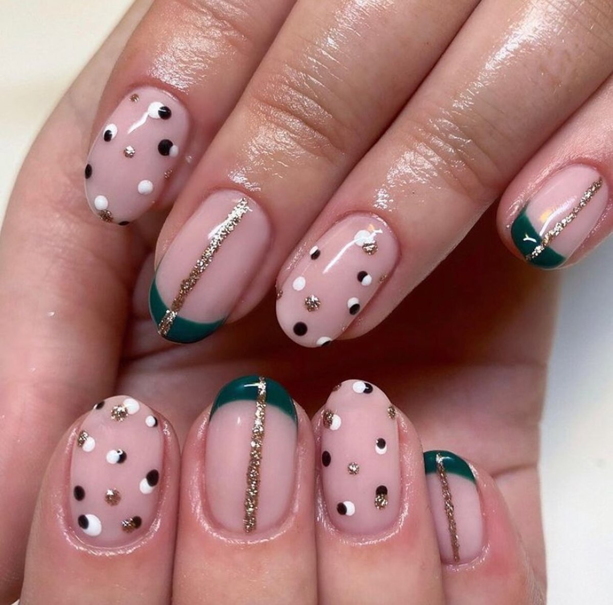 1. Sophisticated Green and Gold Accent Polka Dot Nails