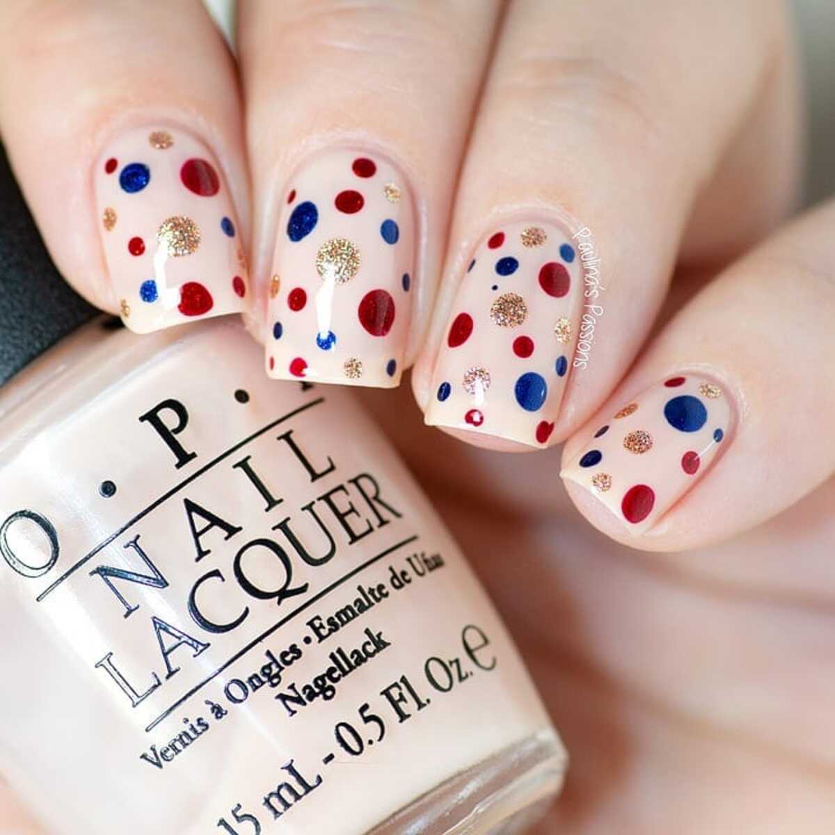 6. Festive Red, Blue, and Gold Confetti Nails