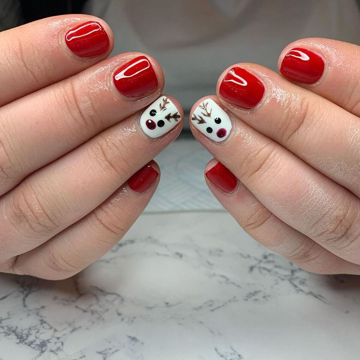 12. Cute Rudolph Accents on Glossy Red Nails