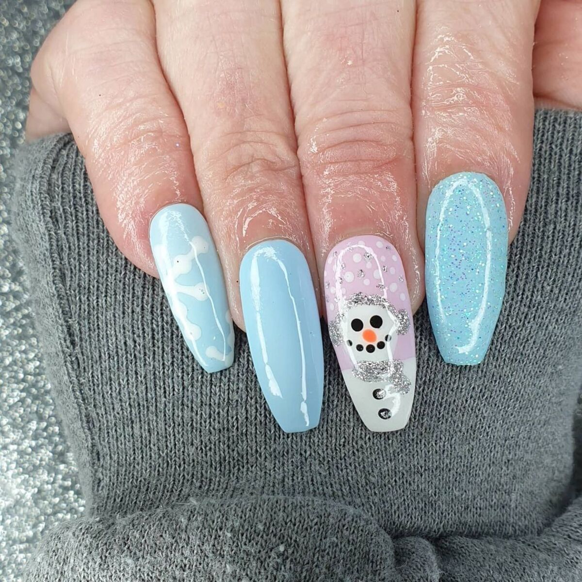 25. Frosty Blue Snowman Nail Art