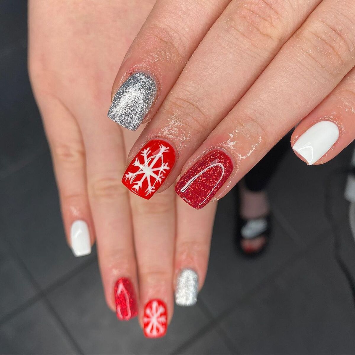 5. Bold Red and Silver Snowflake Nails