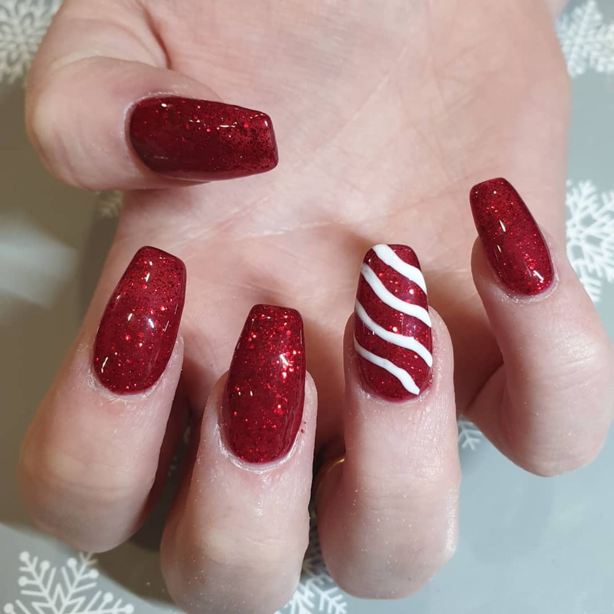 16. Red Glitter Nails with Single Candy Cane Stripe