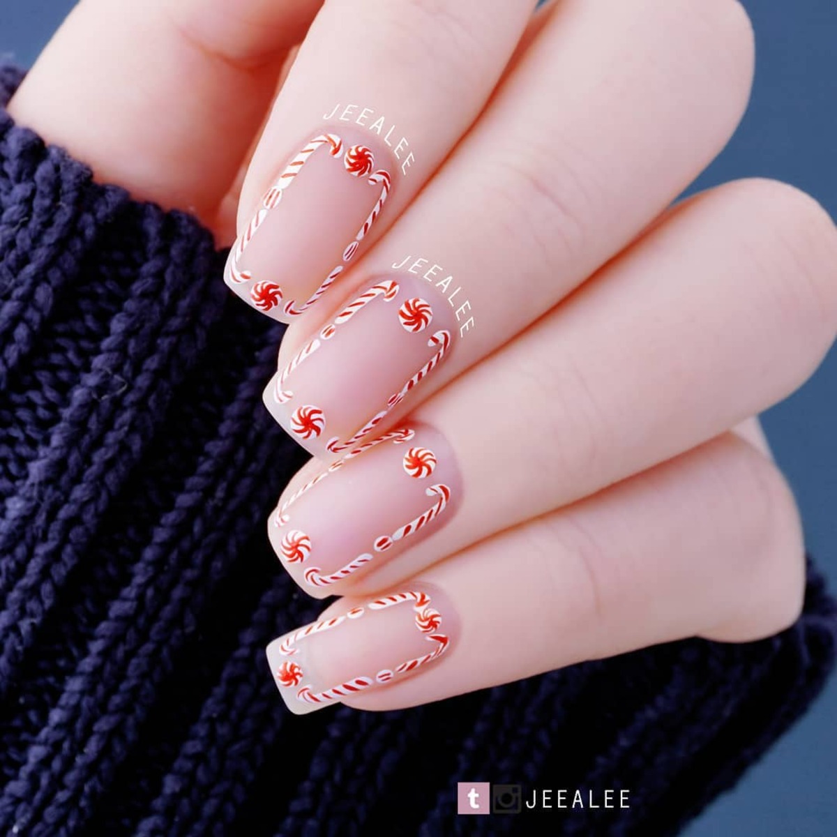 21. Delicate Candy Cane Borders on Nude Nails