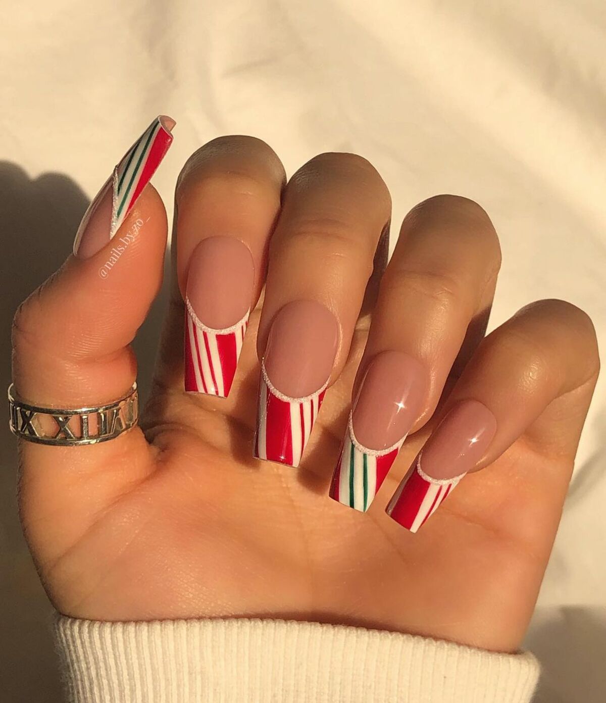 27. Modern Candy Cane French Tips with Green Accents